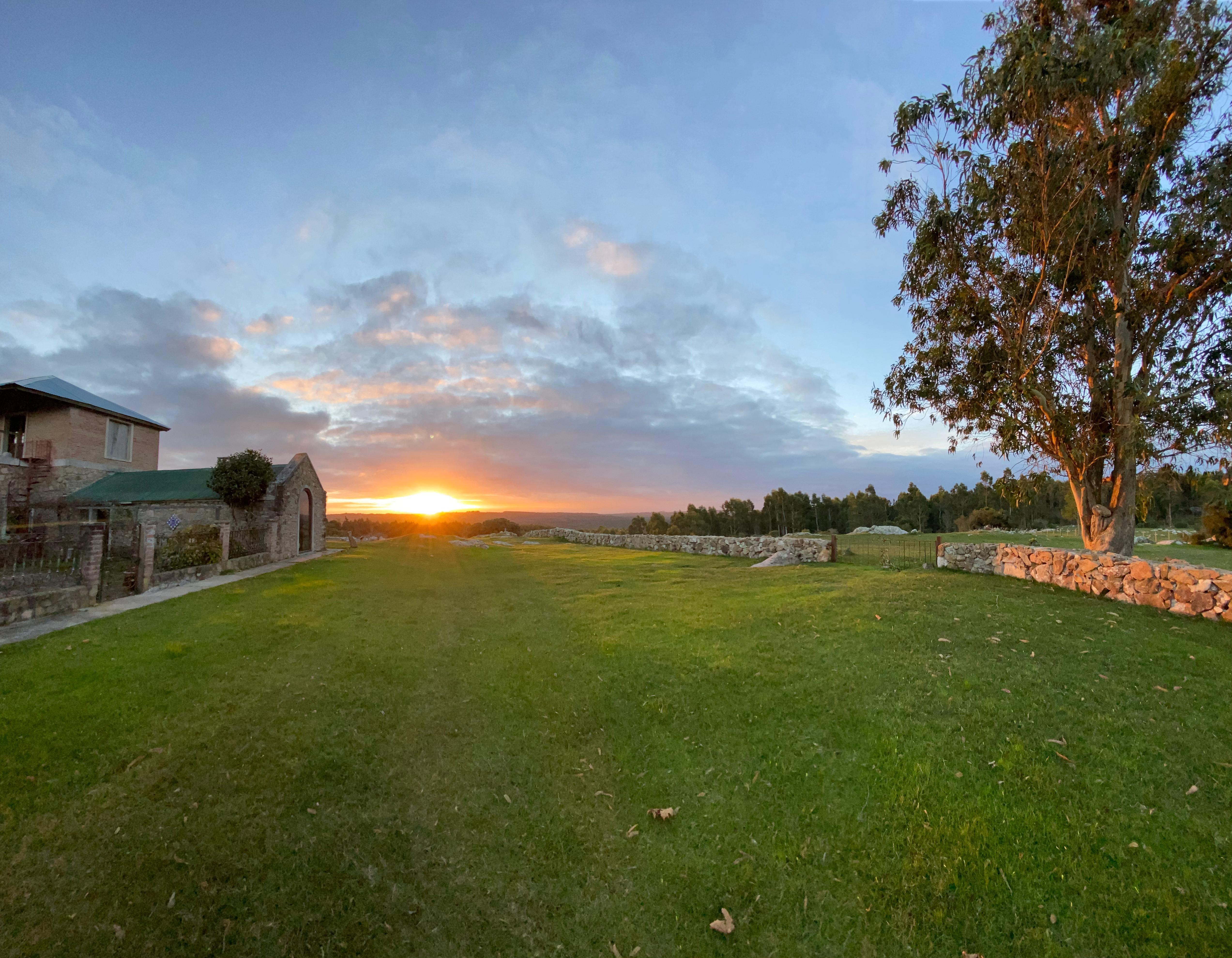 Mountain farm house at sunset